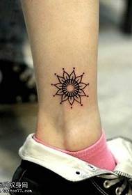Small fresh flower totem tattoo pattern on the legs
