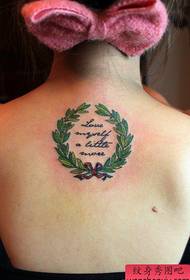 Beautiful garland and letter tattoo pattern on the back of the girl