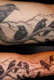 Arm crow sitting on tree tattoo pattern