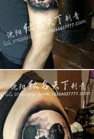 boys arm a realistic black and white skull tattoo pattern