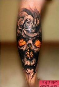 a fine skull rose tattoo tattoo on the calf