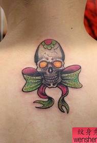 girl's back small skull and bow Tattoo pattern