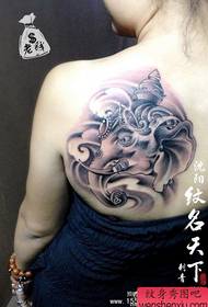 Girl's back shoulders a stylish black and white elephant god tattoo pattern
