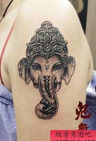 a girl's arm is a beautiful black and white elephant tattoo