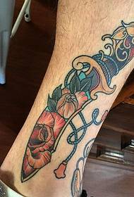 Floral dagger tattoo on the ankle