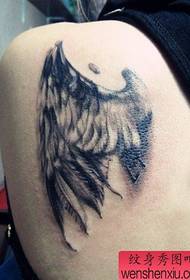 a realistic wing tattoo pattern on the back