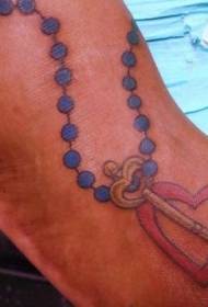 Leg color rosary with love key tattoo pattern
