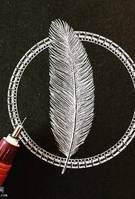 Manuscript e feather tattoo maitiro