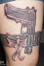 Beautiful pistol tattoo pattern on the legs