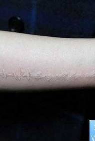 Arm white cardiogram with letter tattoo pattern
