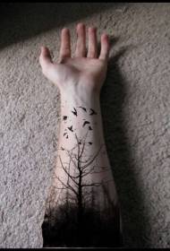 black woods and bird tattoos on the man's arm