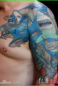 Muskuløs mandlig skulderhaj, der bryder tatoveringsmønster