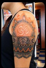 decorative Sanskrit tattoo pattern on the female left arm
