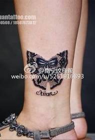 Lace bow tattoo on the ankle