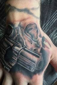 Hand back realistic style pistol with skull tattoo pattern