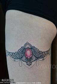 Lace gemstone tattoo on the thigh