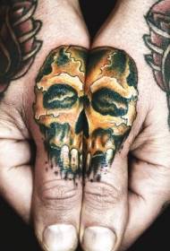Golden skull tattoo pattern on the finger
