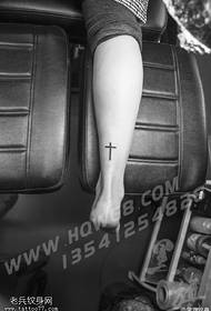 Cross tattoo pattern on the ankle