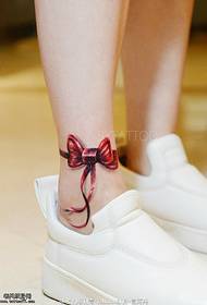 Bow tattoo on the ankle