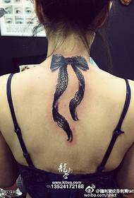 Big bow tattoo on the neck