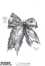 Lace-edged bow tattoo