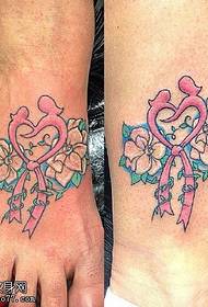 Bow flower tattoo on ankle