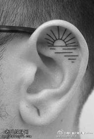 Tattooed sun tattoo pattern in the ear