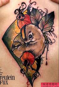 a beautiful bird tattoo under the chest