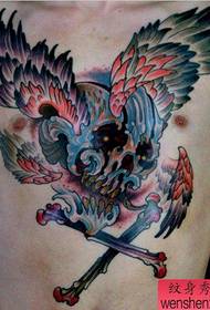 a school style skull wings tattoo on the chest