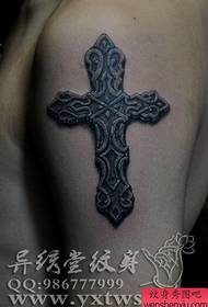 Male arm with a classic stone cross tattoo pattern