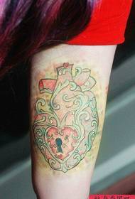 Classic heart lock tattoo pattern on the inside of the arm