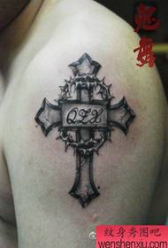 Arm cross with letter tattoo pattern