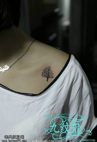 a fresh little tree tattoo on the shoulder
