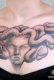 A girl's front chest classic cool Medusa tattoo pattern