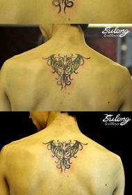 a phoenix legend tattoo pattern on the back of the boy