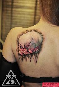a beautiful tattoo on the back of a beautiful woman