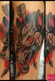 recommended a school-style wolf head tattoo on a calf