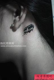 girl ear small bullet tattoo pattern