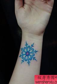girls Beautiful colored snowflake tattoo pattern on the wrist
