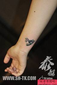 girl's wrist small wooden horse tattoo pattern
