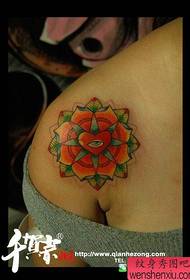 a small and beautiful floral tattoo pattern on the shoulder of a girl