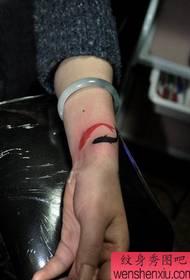 girl's wrist small squid tattoo pattern