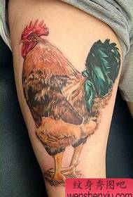 a very realistic cock tattoo on the thigh