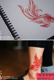 a small goldfish tattoo pattern on the leg
