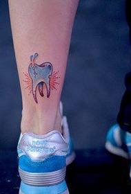 a popular alternative tooth tattoo pattern on the girl's leg