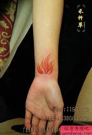 girl's wrist at the beautiful color flame tattoo pattern