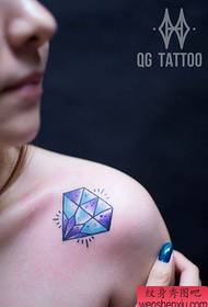 a beautifully popular small diamond tattoo on the shoulder of a girl