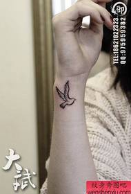 girl's wrist small totem pigeon tattoo pattern