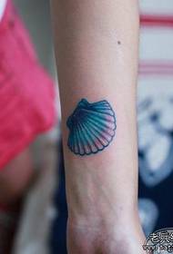girl arm colored small shell tattoo pattern