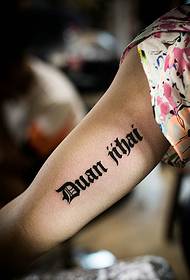 girl's arm inside simple English word tattoo tattoo